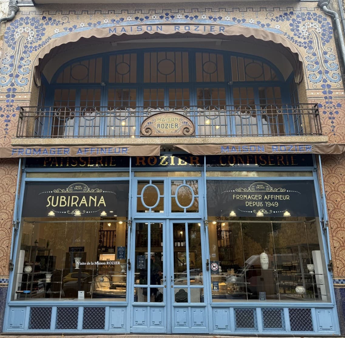 Escapade entre amis en Auvergne : Mosaïque bleue gravée "Gentil Bourdet, mosaïstes, Billancourt", signature d'atelier sur la façade de la Maison Rozier.
