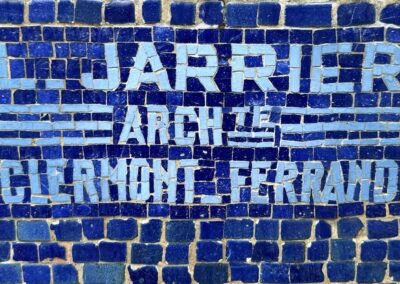 Voyage sur mesure en Auvergne : Mosaïque bleue gravée "L. Jarrier Architecte Clermont-Ferrand", signature d'architecte sur une façade de La Bourboule